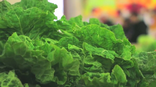 Collard greens on a market stall. Close up of collard greens in market store