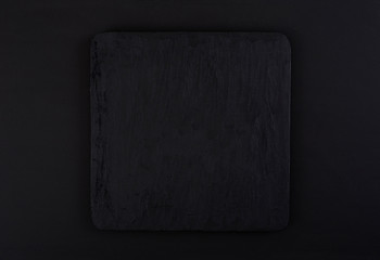 Naklejka premium textured black marble platform on black background