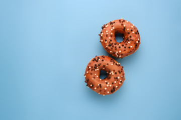 Tradition Jewish holiday sweets, donut sufganioyt with sugar powder and jam  on blue background top view with copy space