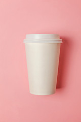 Simply flat lay design paper coffee cup on pink pastel colorful trendy background. Takeaway drink container. Good morning wake up awake concept. Template of drink mockup. Top view copy space