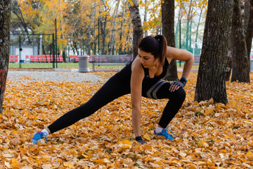 Khabarovsk, Russia - Oct 07, 2018: An attractive woman in sports clothes doing sports exercises in...