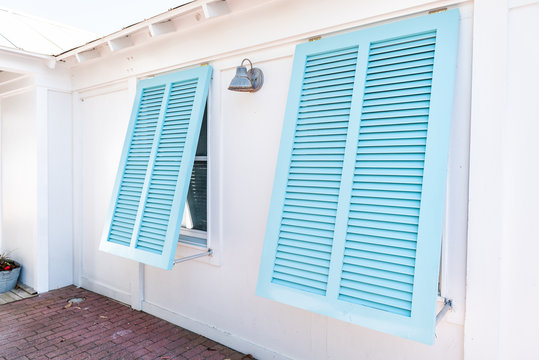 Pastel Turquoise Blue Colorful Hurricane Window Shutters Closeup Architecture Open Exterior Of House In Florida Beach Home During Sunny Day, Painted