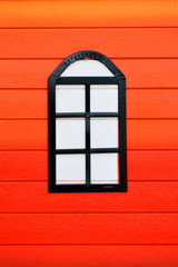 red wall background with window on wood wall