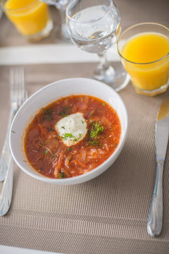 Borscht, Red Soup Made of Beetroot and Vegetables  and Sour Cream Served with Garlic Rolls, Traditional Dish of Ukrainian, Russian and Polish Cuisine
