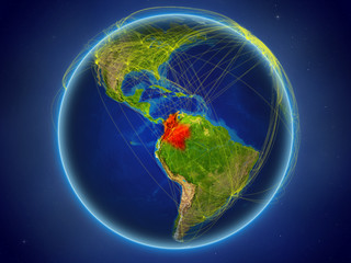 Colombia from space on planet Earth with digital network representing international communication, technology and travel.