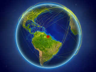 Suriname from space on planet Earth with digital network representing international communication, technology and travel.