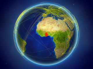 Ghana from space on planet Earth with digital network representing international communication, technology and travel.