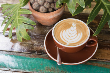 Hot coffee latte with beautiful milk foam art in ceramic glass.