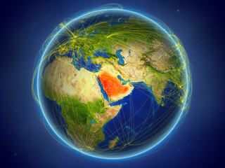 Saudi Arabia from space on planet Earth with digital network representing international communication, technology and travel.