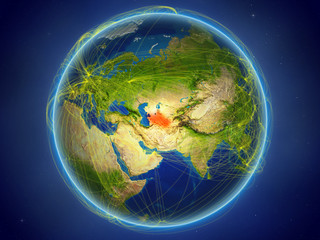 Turkmenistan from space on planet Earth with digital network representing international communication, technology and travel.