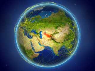 Uzbekistan from space on planet Earth with digital network representing international communication, technology and travel.