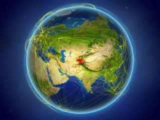 Tajikistan from space on planet Earth with digital network representing international communication, technology and travel.