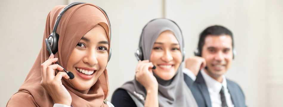 Beautiful Asian muslim women working in call center with team, panoramic banner