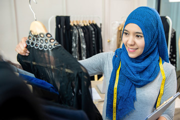 Asian muslim woman designer in her tailor shop
