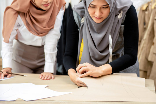 Muslim woman fashion designers working in tailor shop