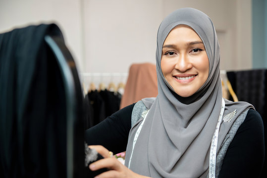 Asian muslim woman designer in her tailor shop
