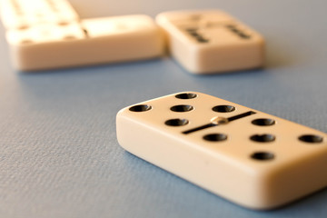Playing dominoes on a blue background . Domino concept