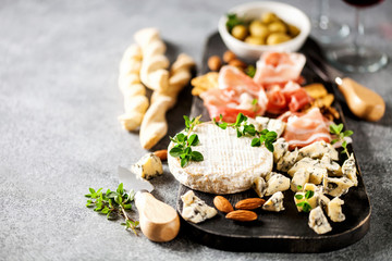 Cheese variety,  olives,  Prosciutto and wine