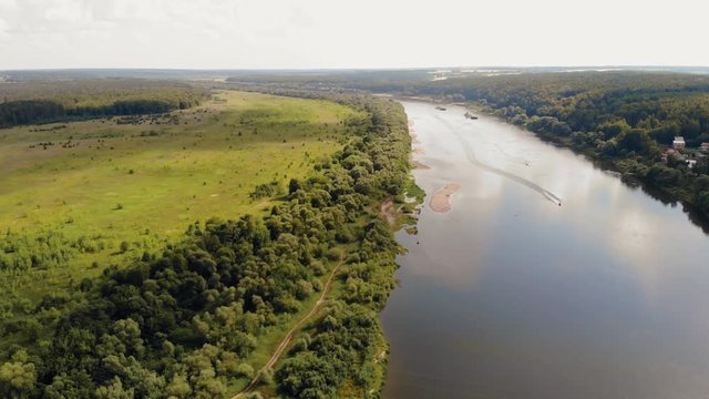 The motor boat floats down the river. Aerial view. 4K