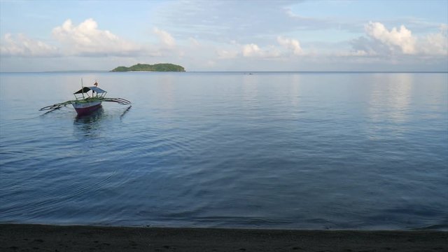 Outrigger boat off the coast of Biliran Island at Agta Beach overlooking Dalutan Island.