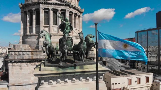 Aerial drone view of Buenos Aires national congress parliament building with dome roof, roman horse carriage statute and argentine flag