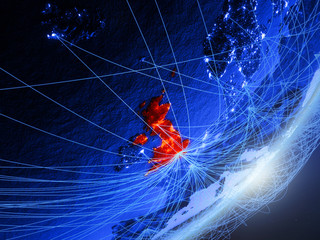 United Kingdom on green model of planet Earth with network at night. Concept of blue digital technology, communication and travel.