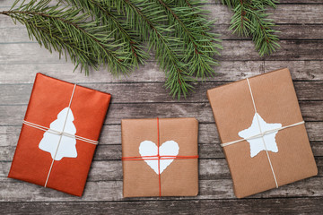 Christmas gifts with fir-tree on wooden background.
