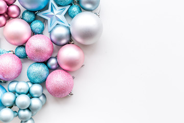 Christmas and New Year symbols. Toys for festive tree. Blue and pink balls and stars on white background top view copy space border
