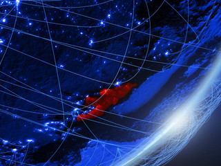 Kyrgyzstan on green model of planet Earth with network at night. Concept of blue digital technology, communication and travel.