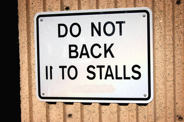 do not back into parking stalls sign