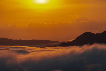Beautiful dramatic sunset in the mountains. Landscape lot of fog Phu Thok Mountain at Chiang Khan ,Loei Province in Thailand.