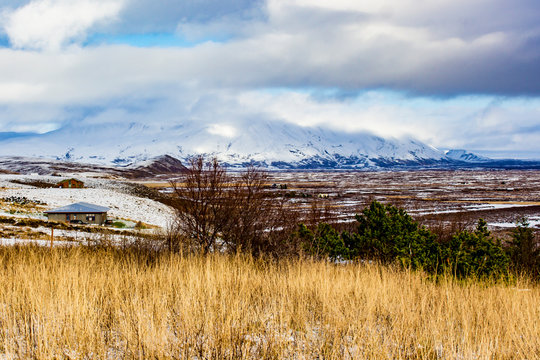 View across a Meadow to the Tundra and Snowy Mountains in the Horizon in the Golden Circle of Iceland