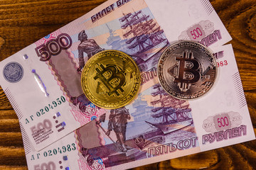 Bitcoin coins on the russian five hundred rubles banknotes