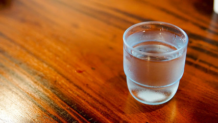 cool water glass on a wooden table