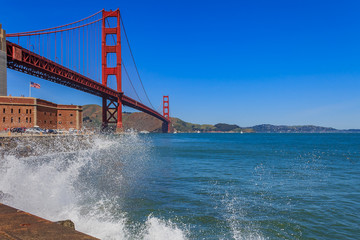 Waves crashing by the iconic Golden Gate Bridge in San Francisco, CA