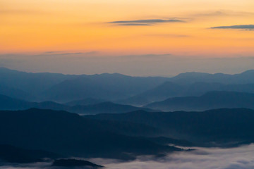  sunset overlooking mountains with Mist