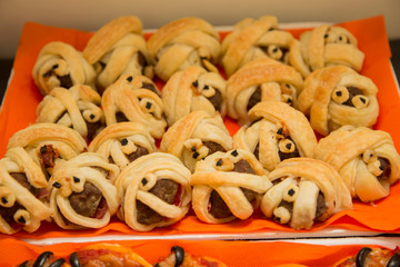 horizontal image with detail of a tray of savory appetizers decorated for halloween party