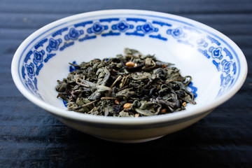green tea leaves in a ceramic bowl