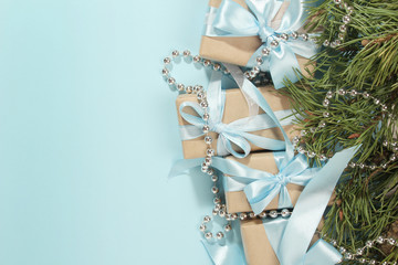 Gift boxes wrapped in craft paper with blue satin ribbons