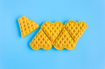 5 Pieces in Row Heart Shape Waffle on Blue Pastel Background Minimalist Style