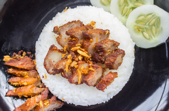Thai Food Fried Pork with Garlic and Cucumber in Black Dish Flatray or Top View
