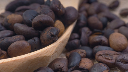 Fototapeta na wymiar Coffee beans closeup with selective focus and crop fragment