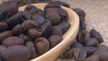 Fototapeta na wymiar Coffee beans closeup with selective focus and crop fragment