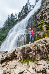 Obraz premium Tourist woman at waterfall Svandalsfossen, Norway