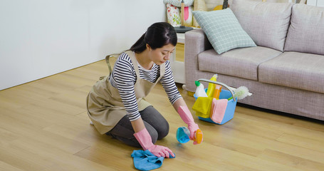 asian girl kneeling down on the wooden ground