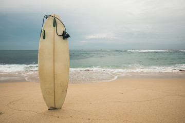 White Surfboard on sandy beach