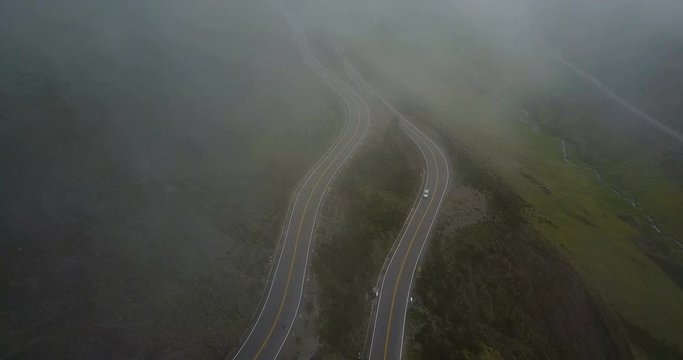 Flying above fog on a empty countryside road