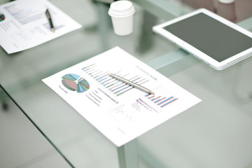 Fototapeta premium close up.financial report on the glass desktop