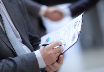 close up. businessman with financial graph on background of bus