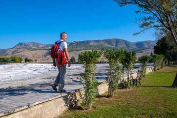 Happy traveler goes along and admires awesome view